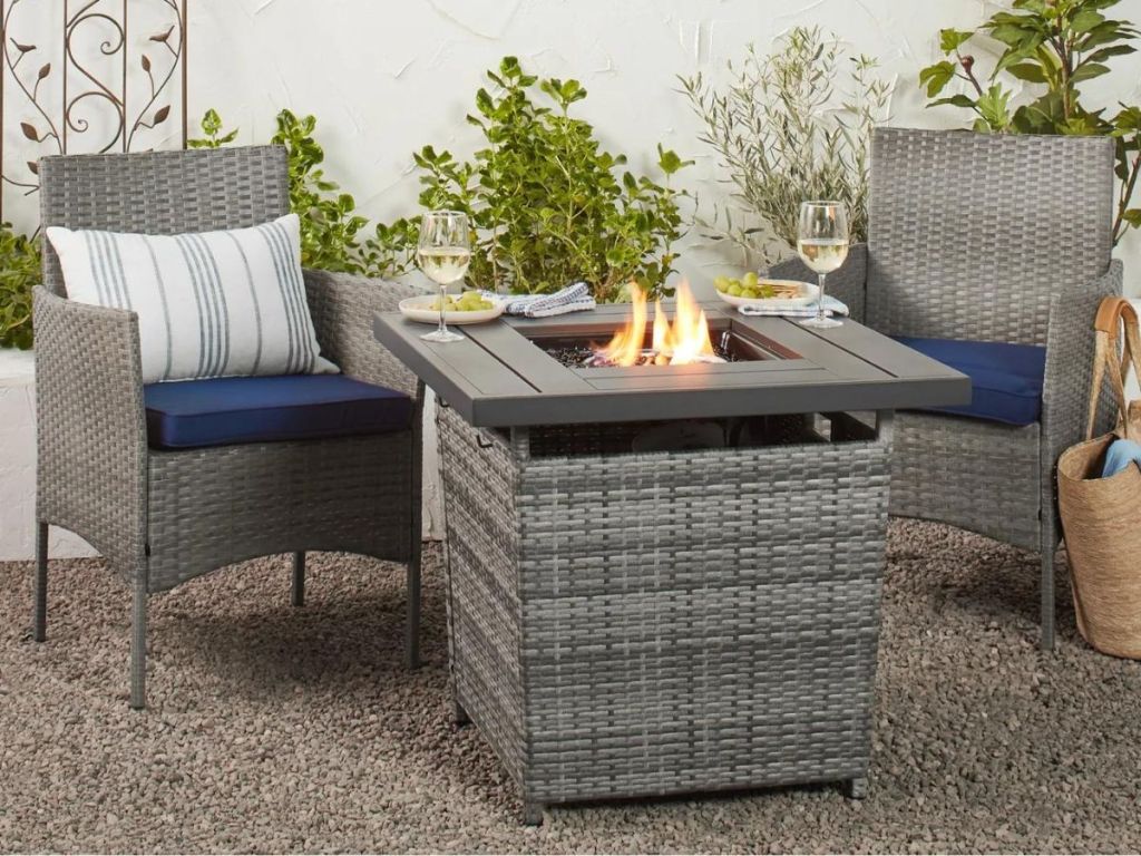 wicker fire pit table and 2 wicker chairs