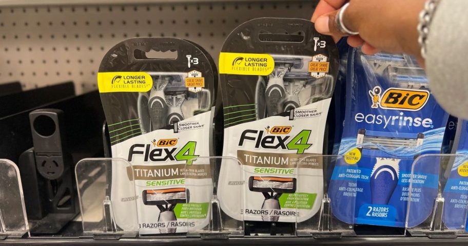 Hand grabbing a BIC Flex 4 razor from a Target shelf