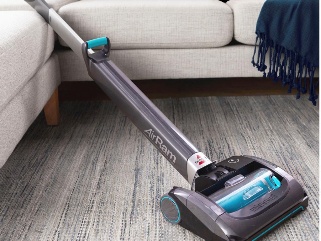 BISSELL AirRam Cordless Vacuum in blue laying flat on the couch