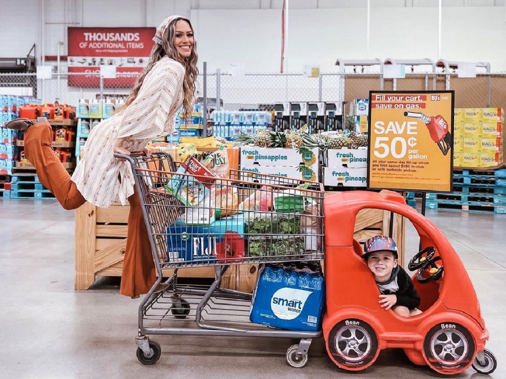 woman riding a BJ's shopping cart