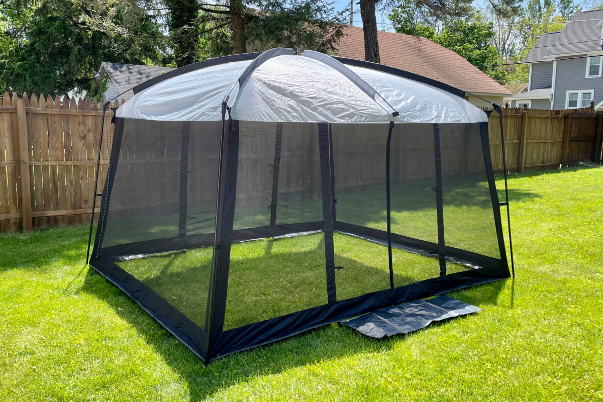A Backyard Essentials Screened In Gazebo Tent erected in a backyard