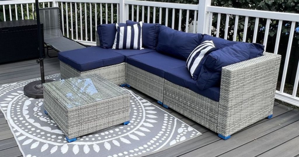 Wicker patio set with blue cushions on a patio