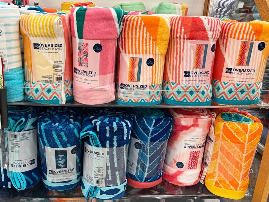 display of rolled up beach towels in store