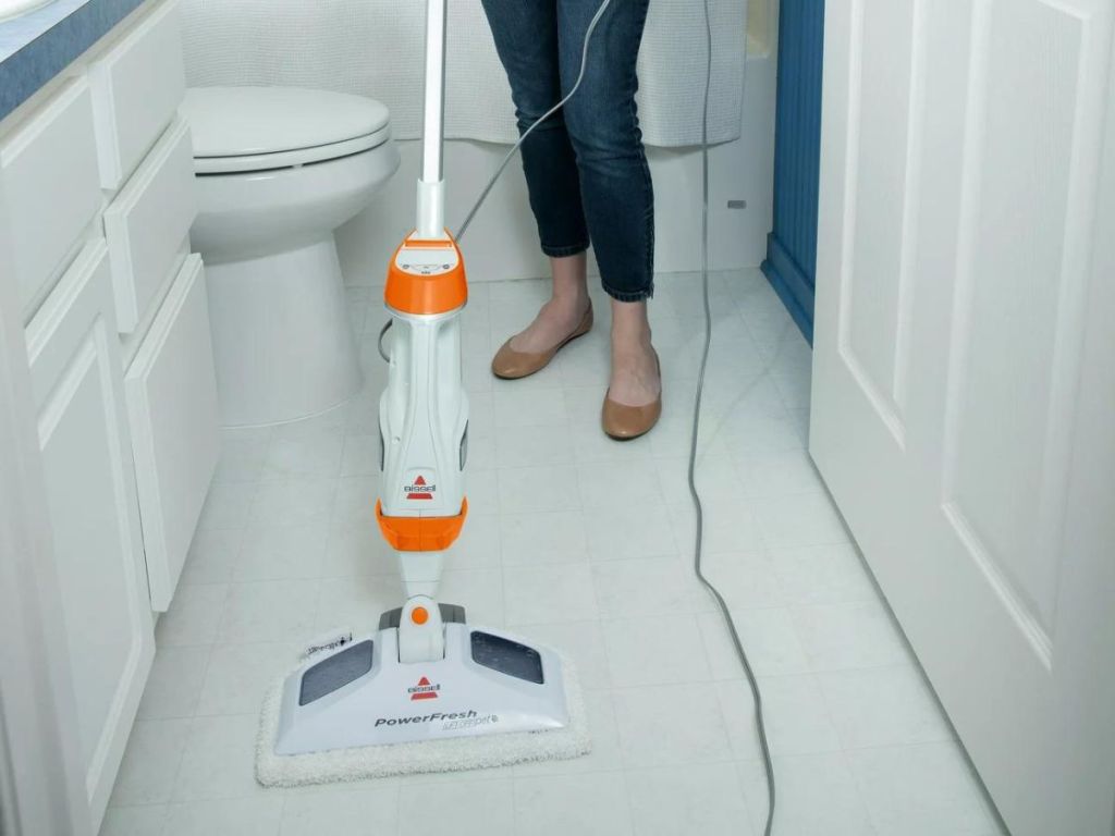 woman using bissel powerfresh mop vac on bathroom floor