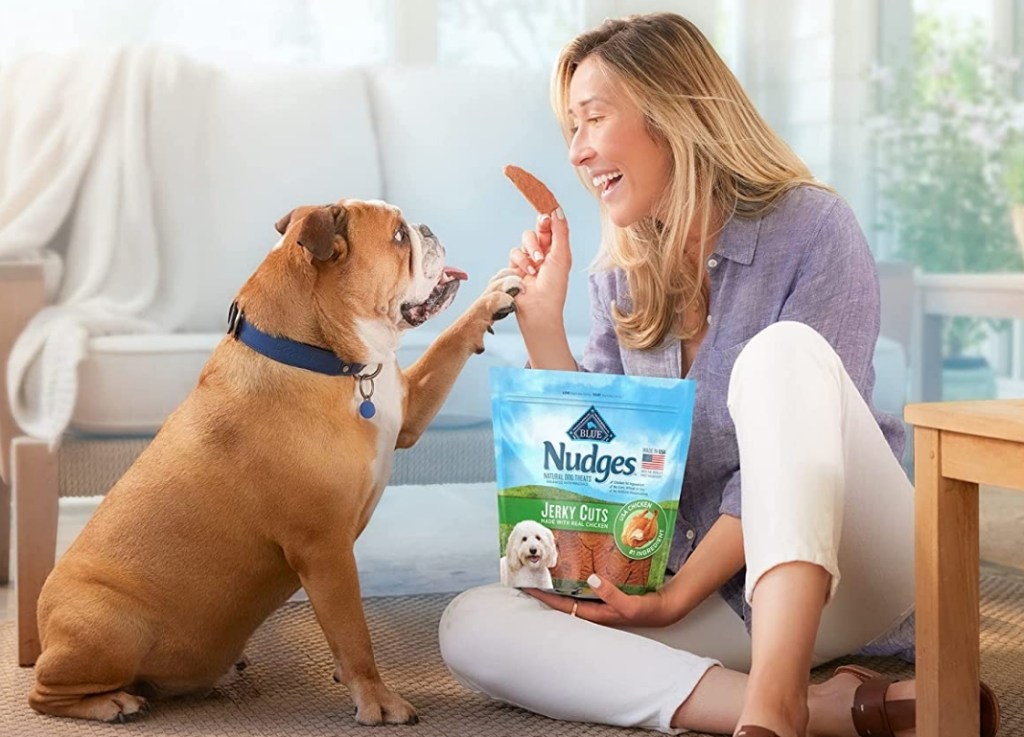 Woman giving a dog a Blue Buffalo Nudges treat