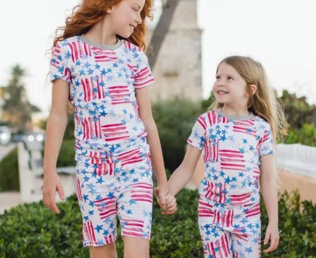 two little girls wearing red white and blue Burt's Bees matching pajamas