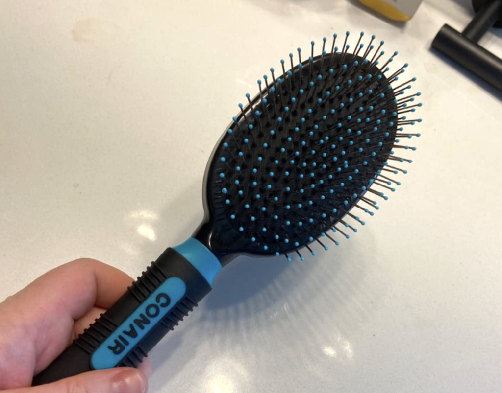 holding a hairbrush