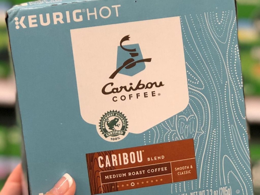 hand holding a box of Caribou K-Cups