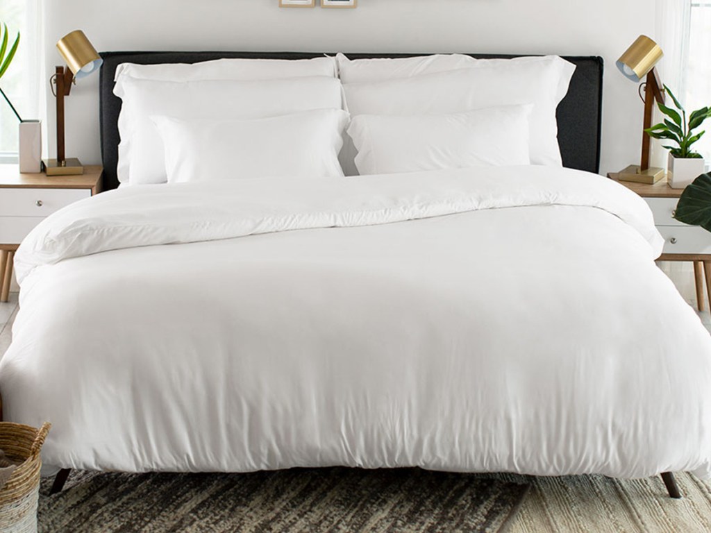 bed with white duvet and white pillow cases