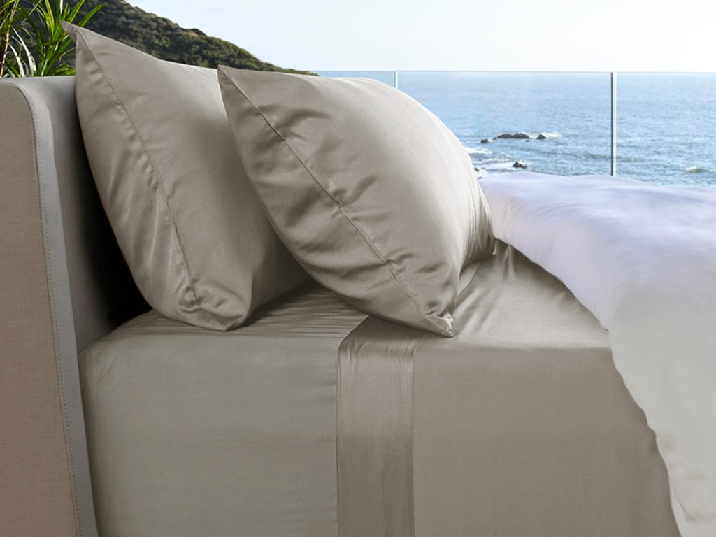 grey sheet set on bed near beach