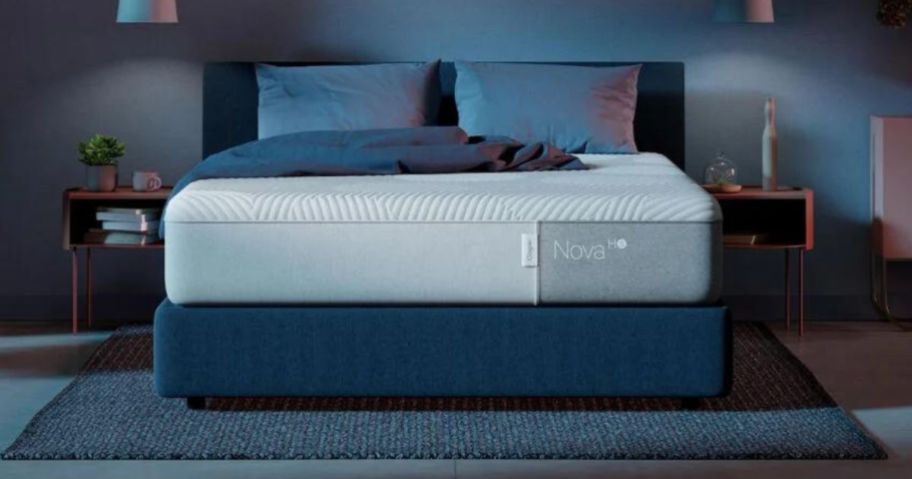 white casper nova mattress on bed with blue pillows and blanket on top
