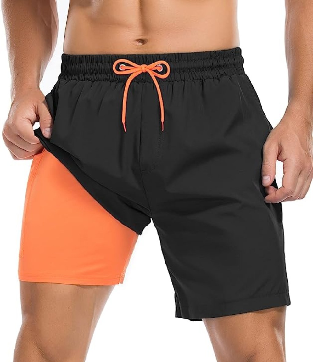Man wearing mens swim trunks with a compression liner from Century Star on Amazon 