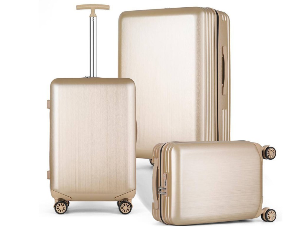Champagne 3 piece luggage displayed by size order