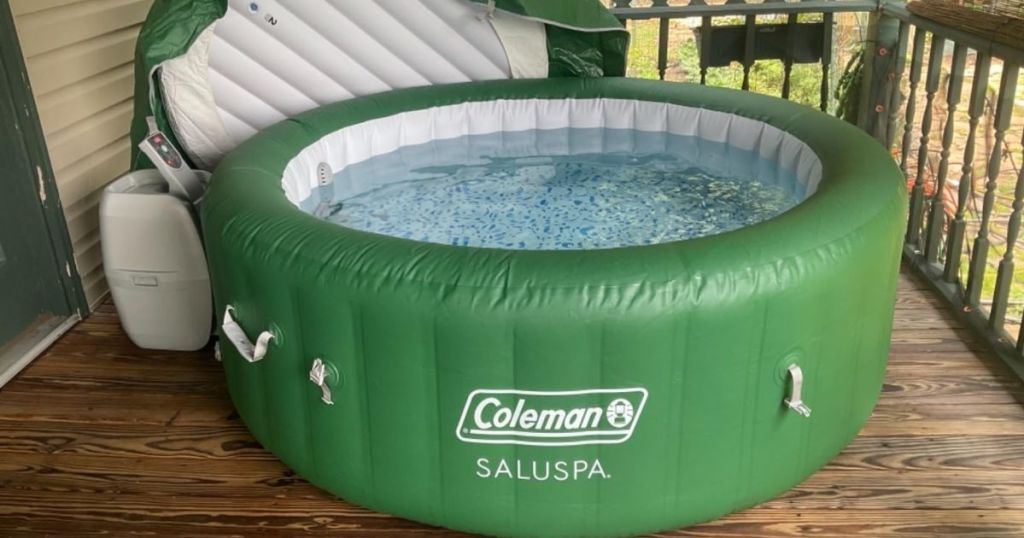 A green inflatable hot tub on a deck 