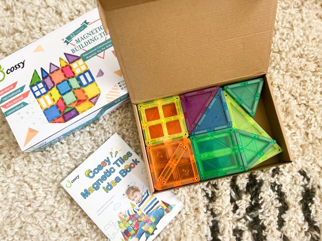 box filled with transparent color magnetic blocks and idea book next to it