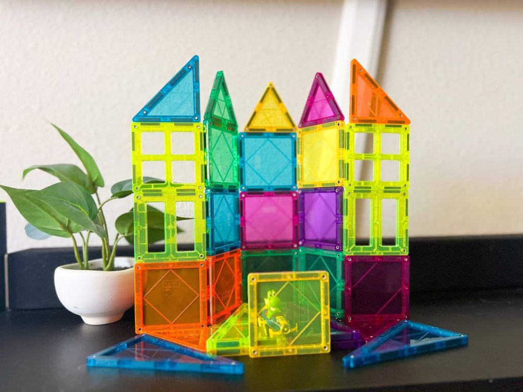 transparent color magnetic blocks built into a structure sitting on black surface
