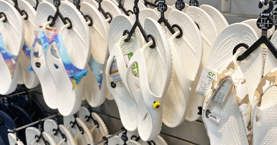 crocs flip flops on display wall in store