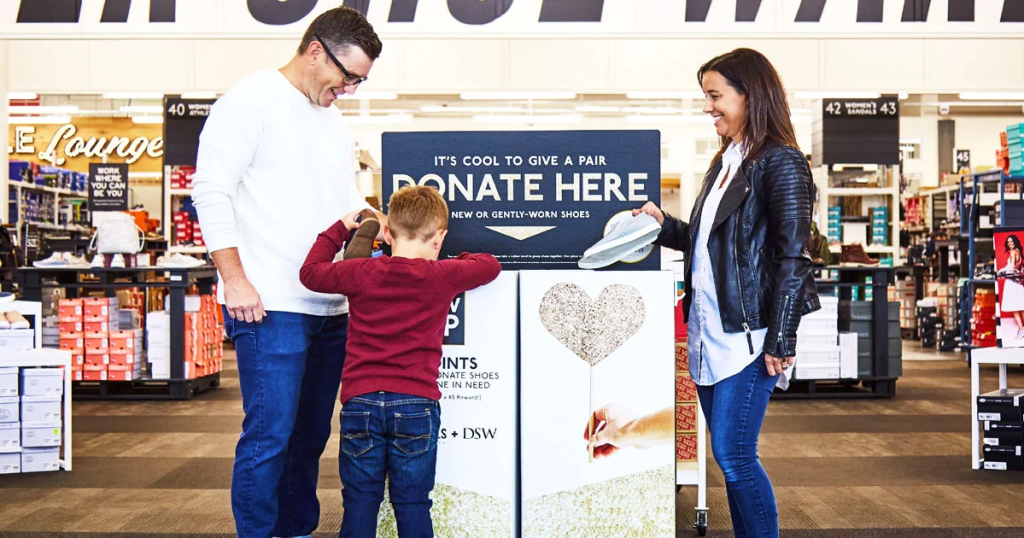 A family putting shoes in the DSW shoe donation bin
