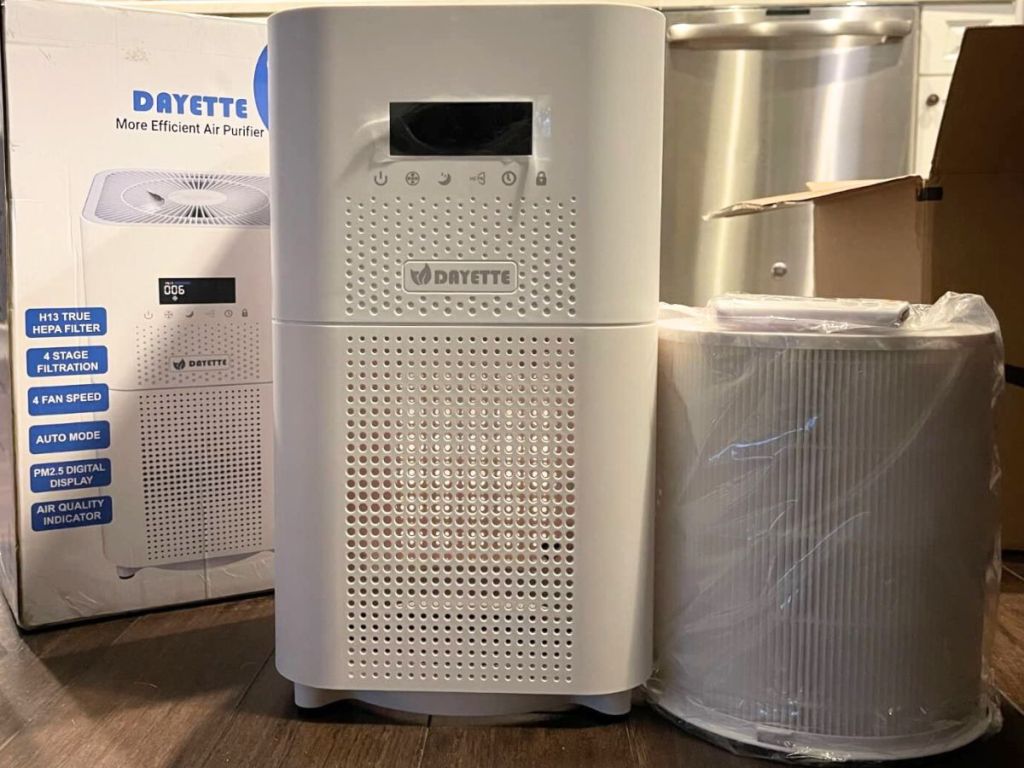Dayette Air Purifie next to the box it comes in and the HEPA filter