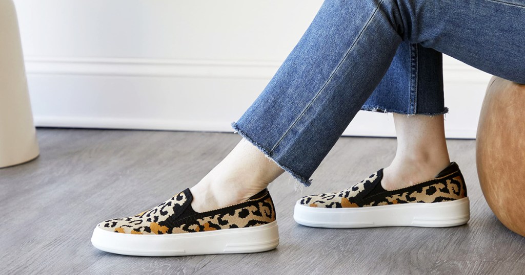 woman wearing jeans and leopard print sneakers