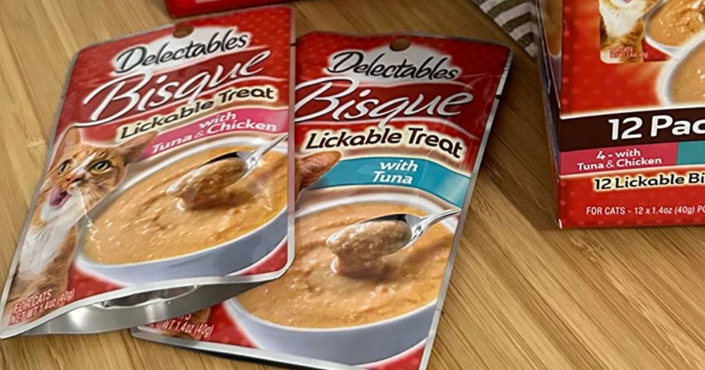 Delectables Bisque Lickable Cat Treats Pouches on a table