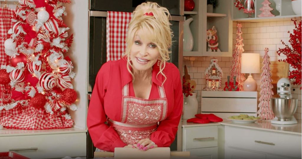 Dolly Parton in a kitchen decorated for the holidays 