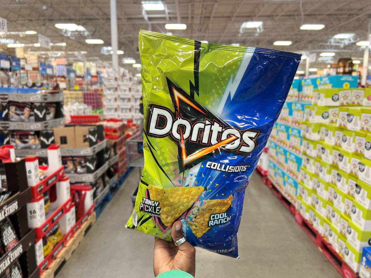 Hand holding up a bag of Doritos