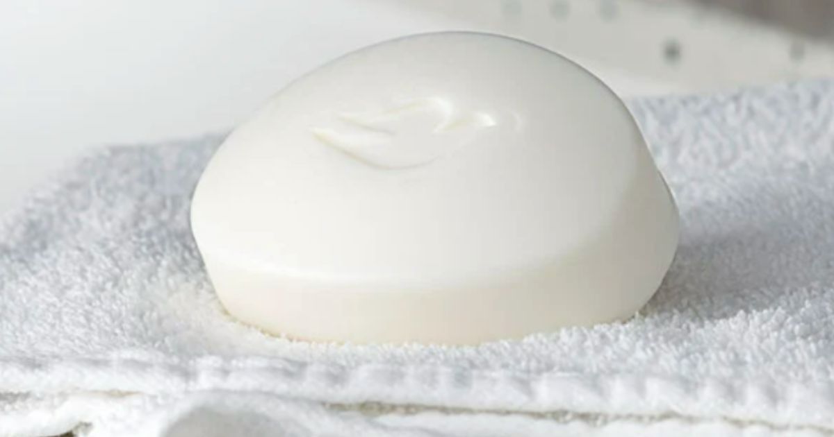 Dove beauty bar sitting on a washcloth by a sink