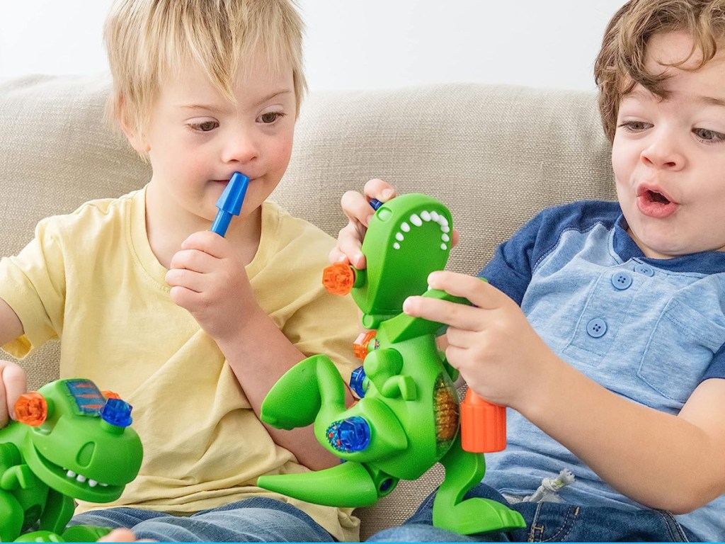 little boys playing with an Educational Insights Design & Drill T-Rex Take Apart Dinosaur Toy