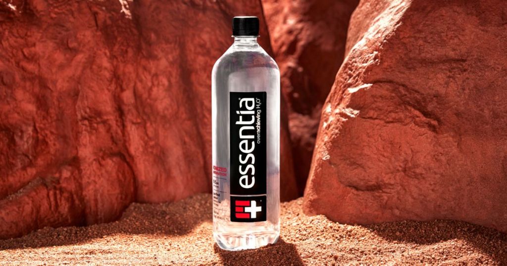 essentia water bottle on sandy ground outdoors