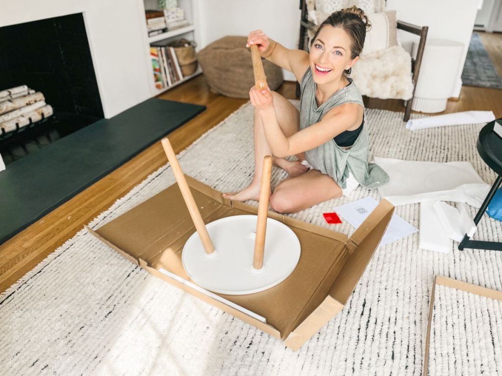 woman putting a table together