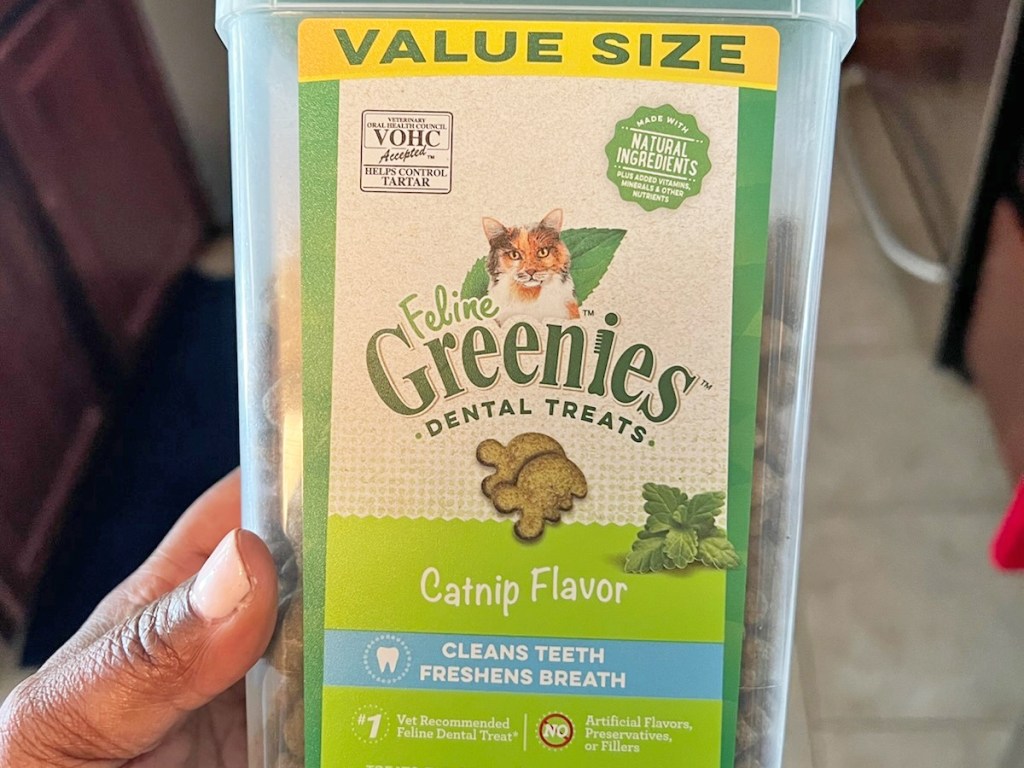 hand holding a container of Feline Greenies Dental Cat Treats