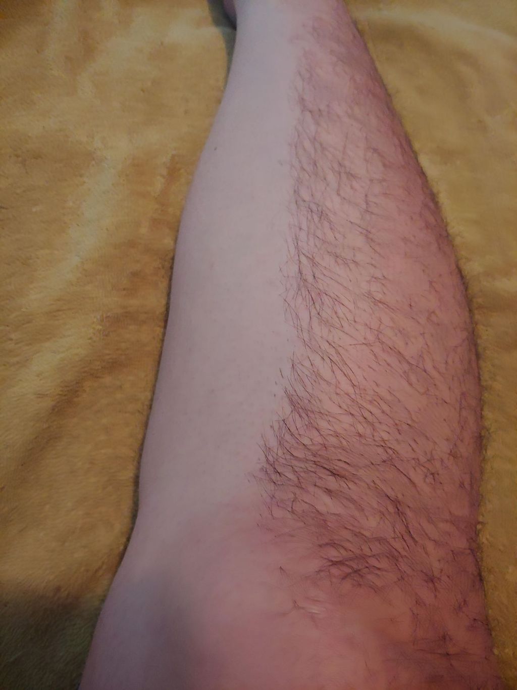 Persons leg with half of it shaved and half hairy