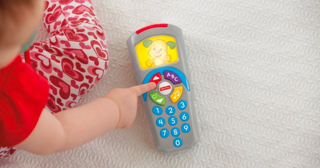 baby playing with Fisher-Price Laugh & Learn Remote