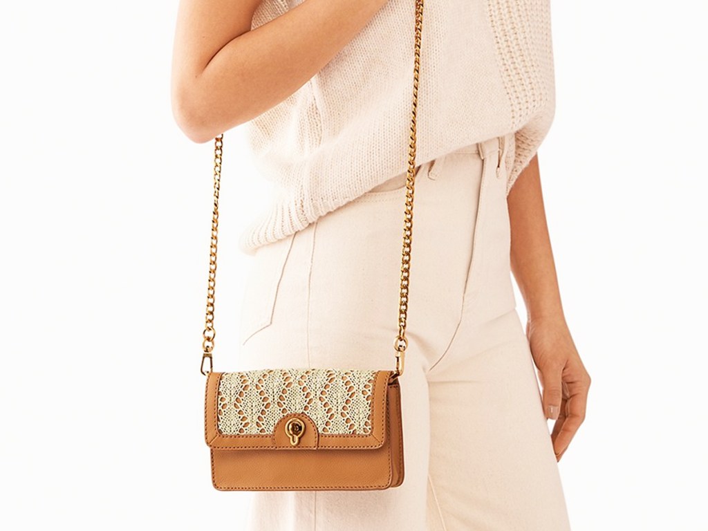 woman with brown fossil crossbody with lace detailing