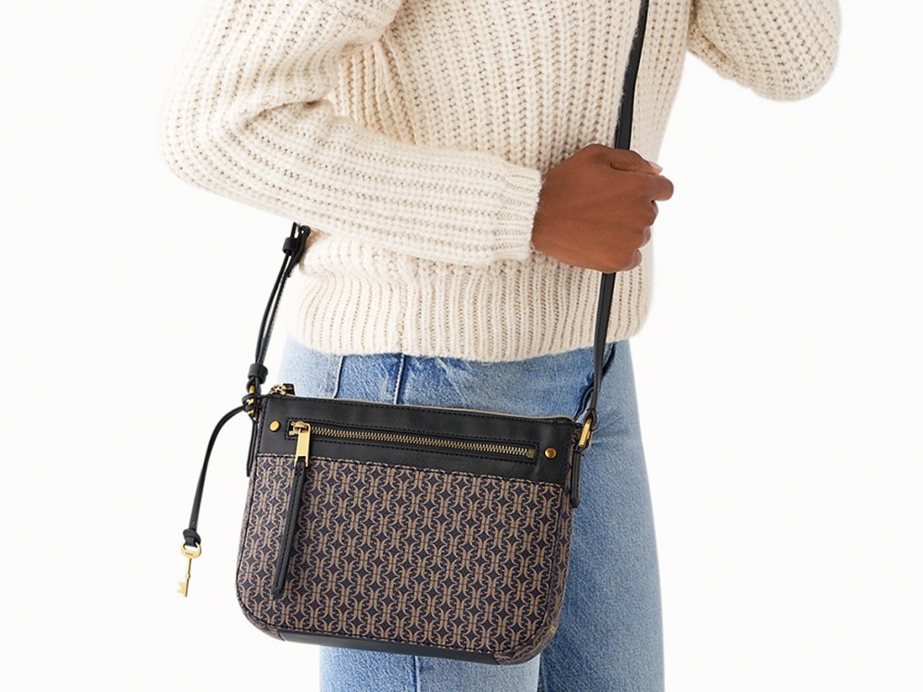 woman in sweater and jeans with black fossil crossbody