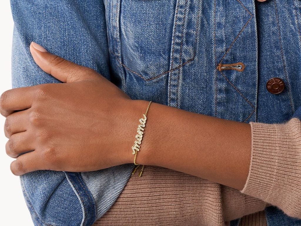 Woman wearing a fossil Mama bracelet on her wrist
