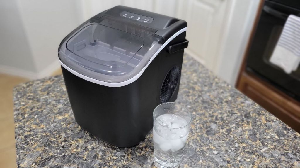 Ice maker with a glass of ice next to it