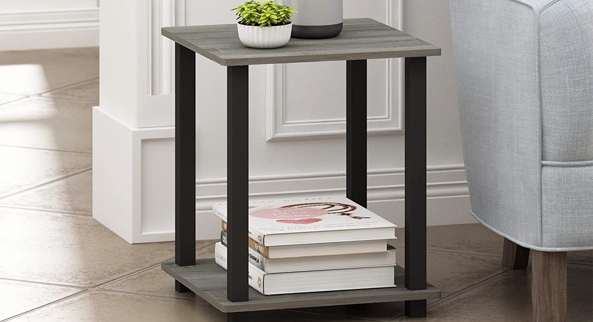 black and grey 2-tier end table with books and vase of tulips on it