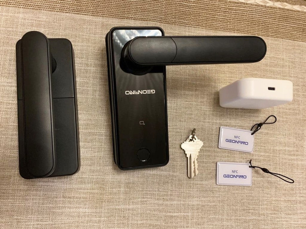 black door lock with keys and key cards