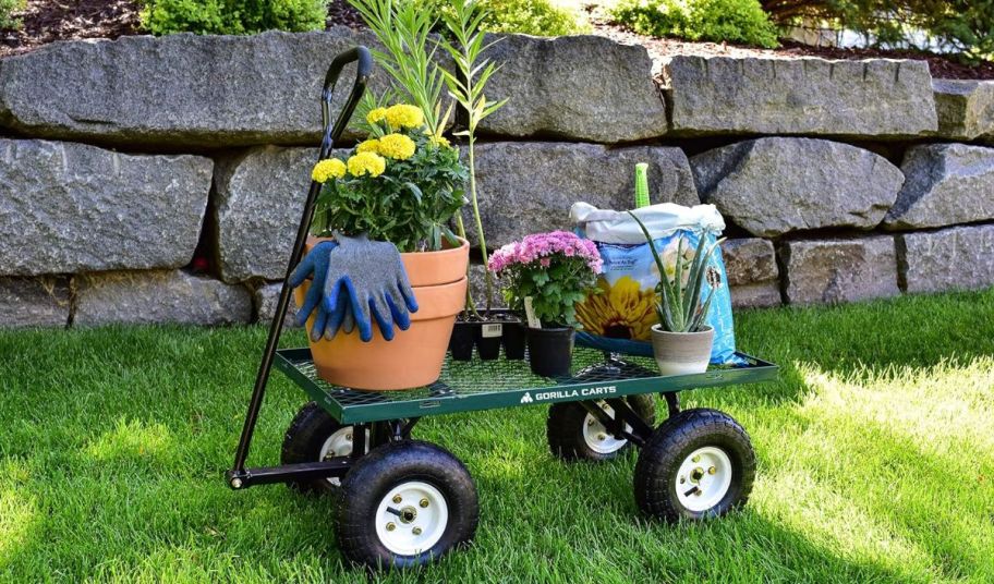 a green mesh garden cart loaded down with gardening supplies