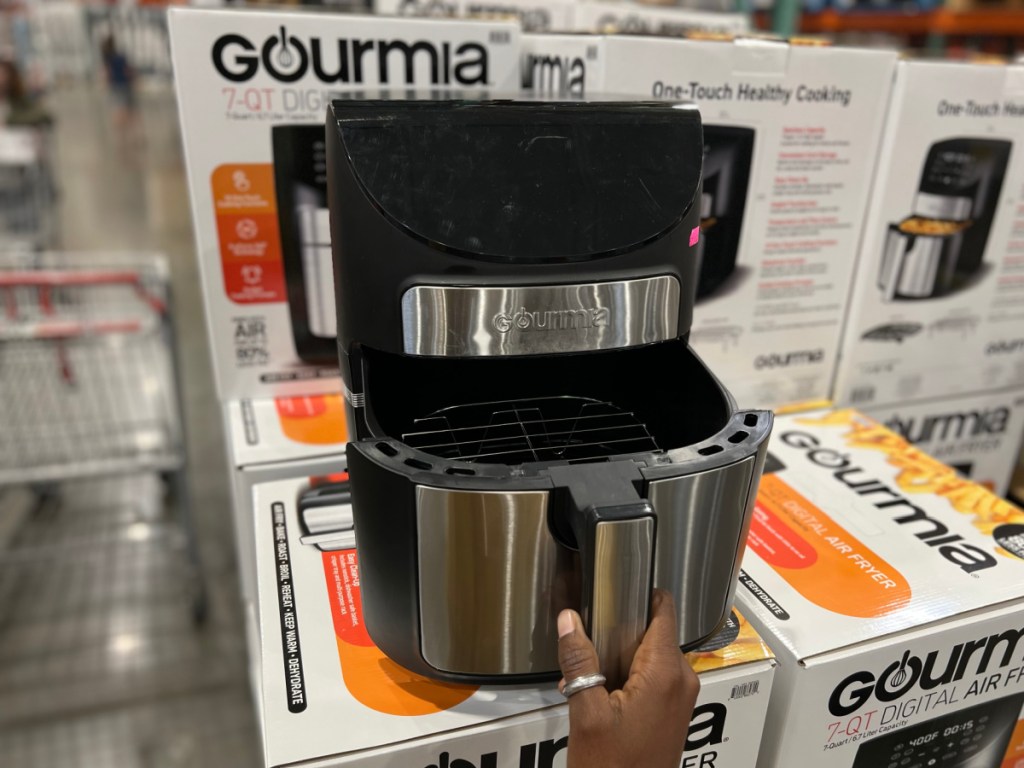 women opening up gourmia air fryer on display at costco