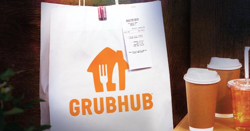 A grubhub delivery bag with a receipt stapled to it next to a bunch of drinks in takeout cups