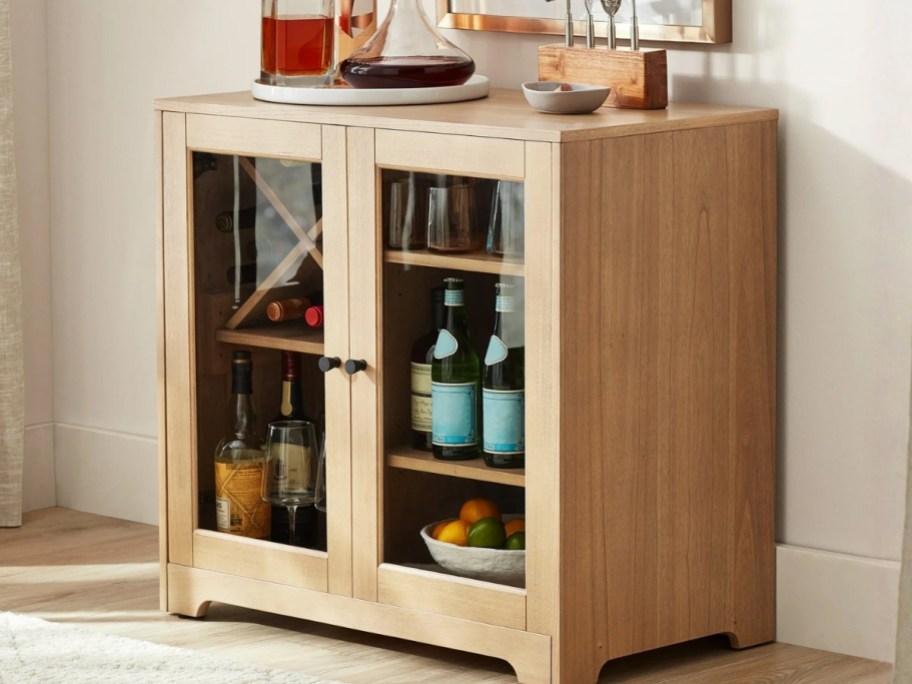 a light oak color bar cabinet