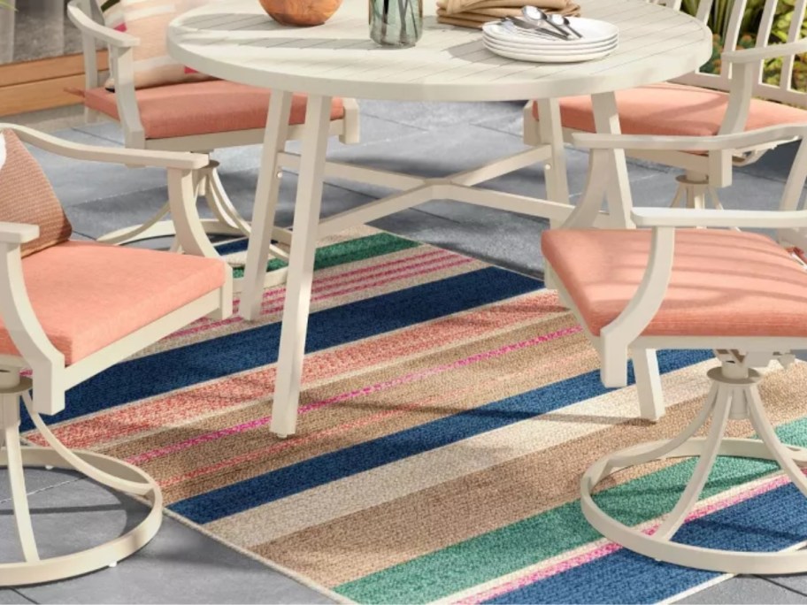 colorful striped outdoor rug under a dining set