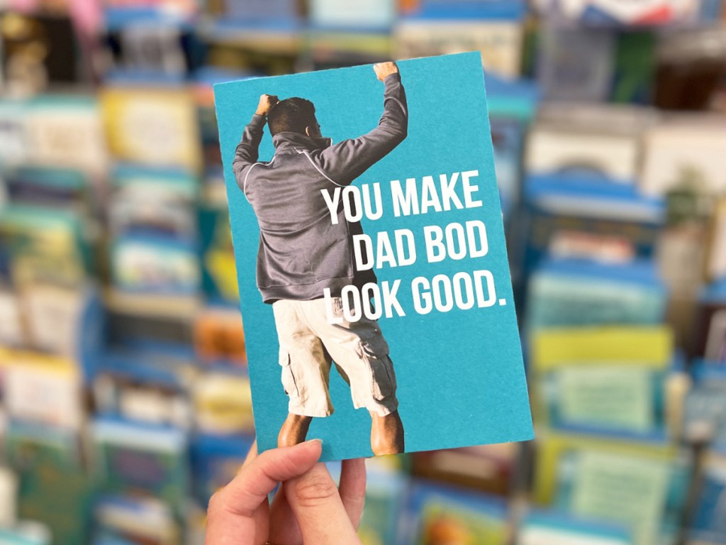 holding a card that says you make dad bod look good