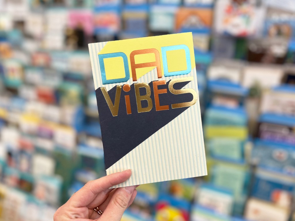 hand holding a card that says dad vibes on it