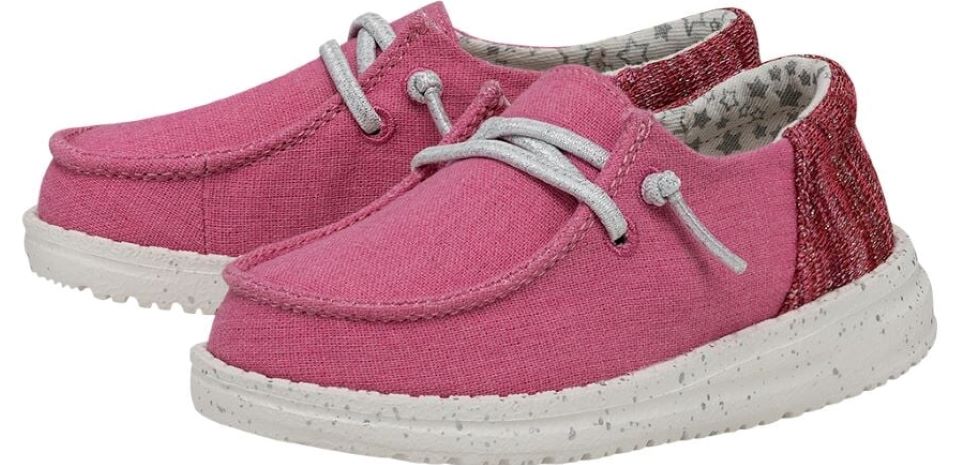 Pair of pink Hey Dude kids shoes with white soles