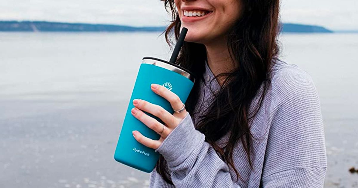 a woman holding a Hydro flask 28 ounce tumbler in pacific blue