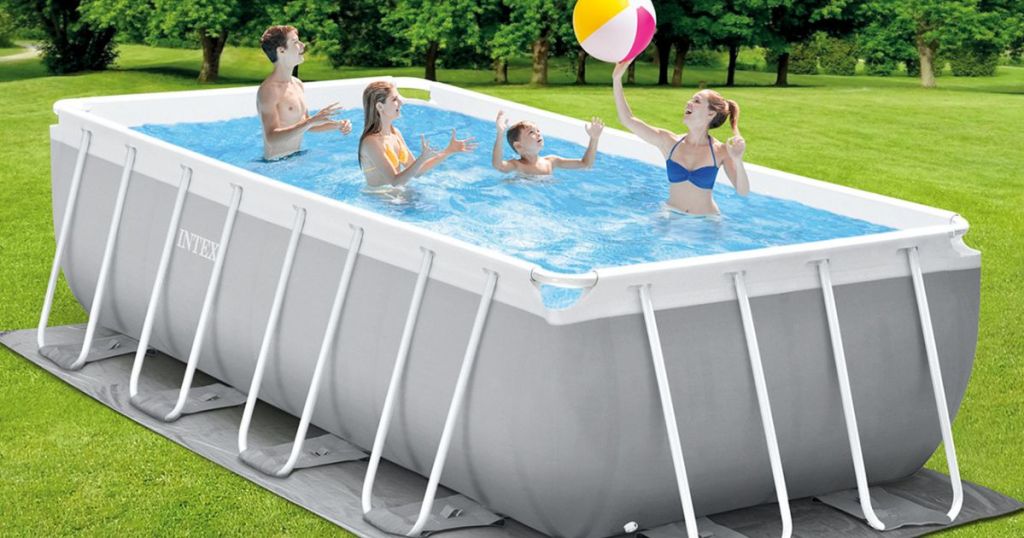 A group of people playing in an above ground pool. 